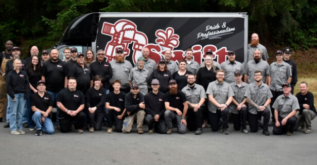 Our staff gathered in front of one of our service trucks.